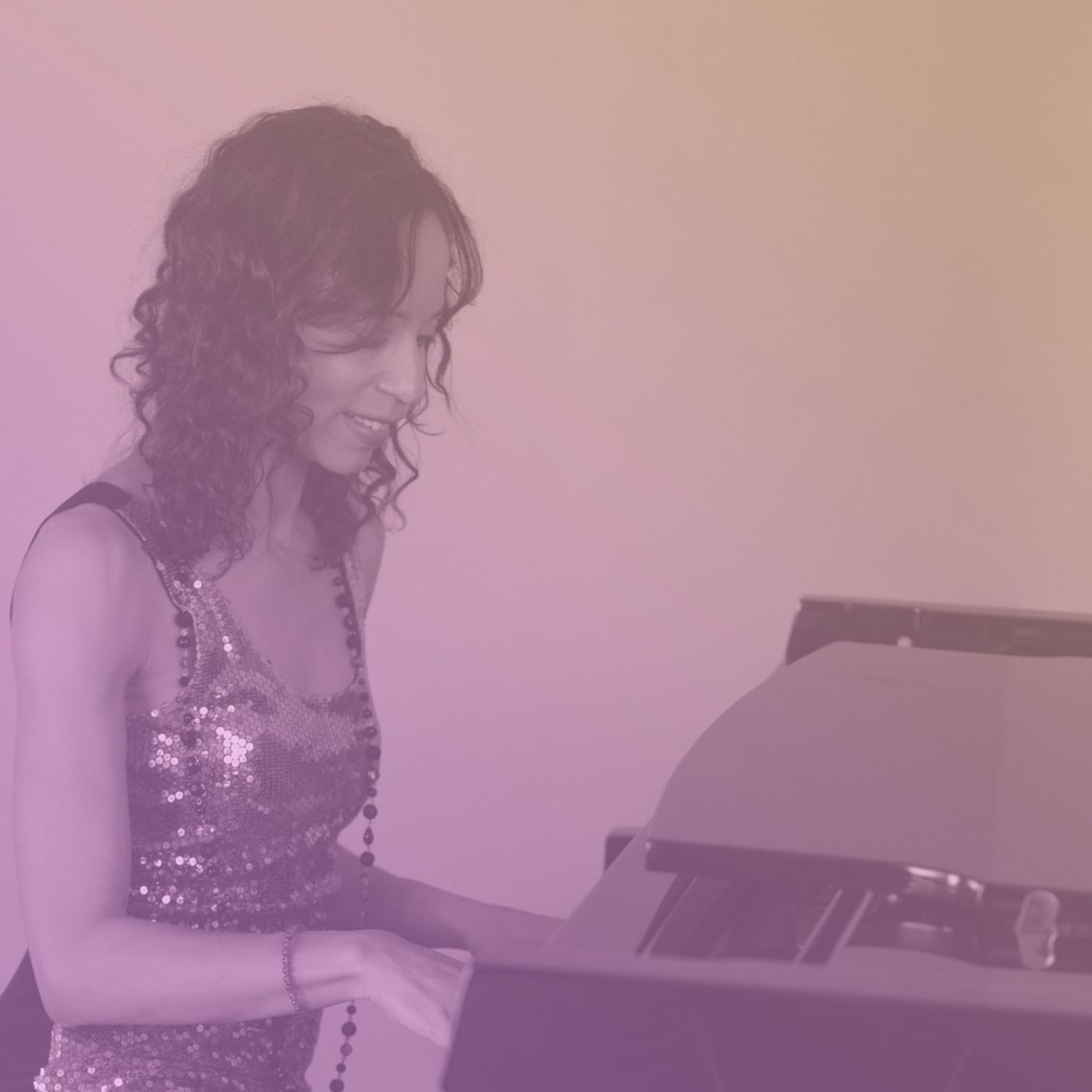 Martha Liz playing keyboard on stage